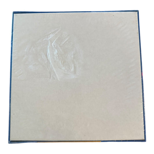Back of puzzle box showing tear in the packaging on a white background