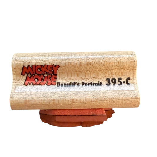 Wooden stamp with 'Mickey Mouse' 395-C branding on a white background