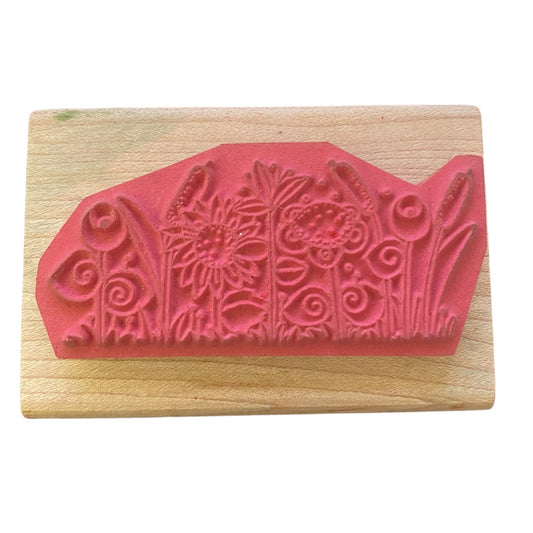 Wooden stamp with floral design on a white background