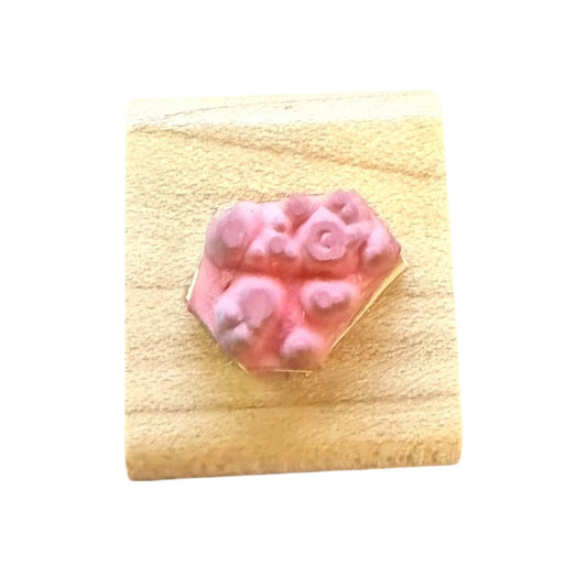 Pink dot stamp on block