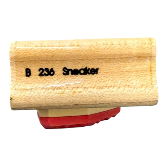 Wood block with b 23 sneaker on a white background