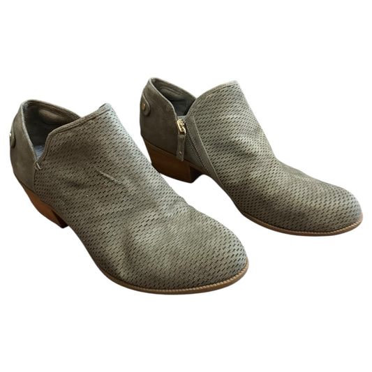 Pair of green textured shoes on a white background