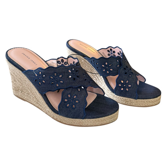 Front side of Navy wedge sandals with floral cutouts on a white background