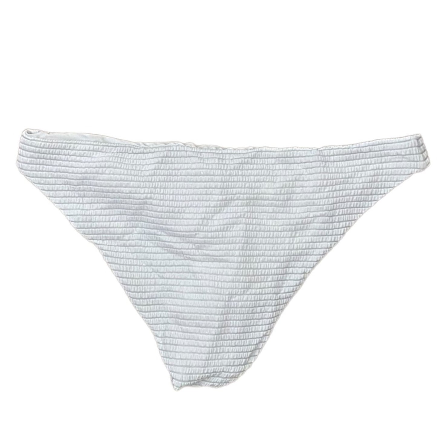 A white textured bikini bottom with a fine horizontal ribbed pattern, laid flat against a solid white background.