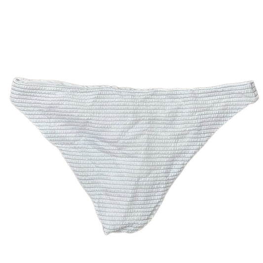 A white textured bikini bottom with a fine horizontal ribbed pattern, laid flat against a solid white background.
