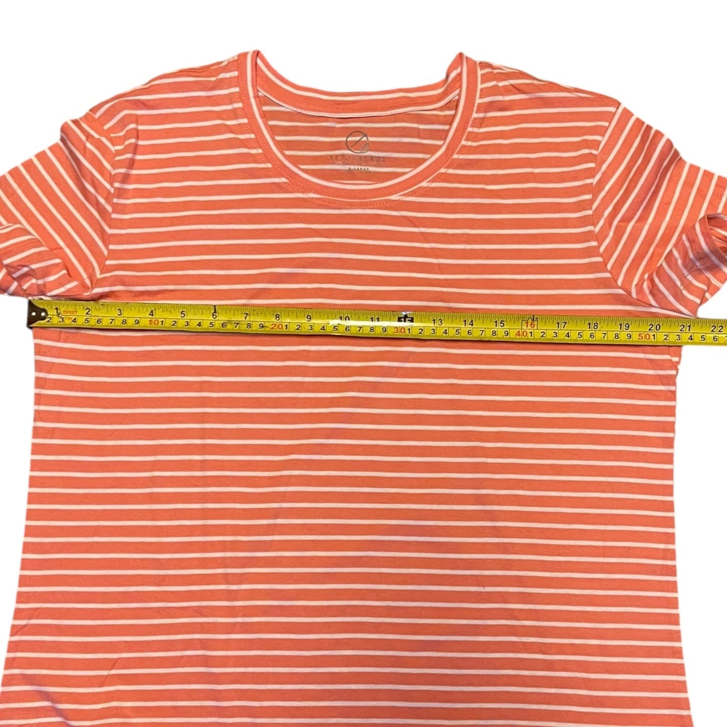 Orange and white striped t-shirt with a measuring tape on a white background