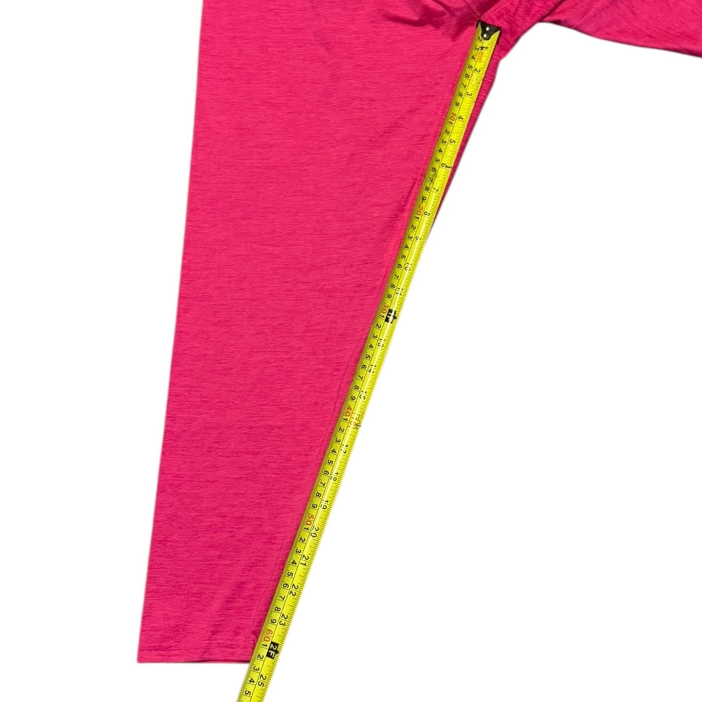 Pink leggings with a measuring tape on a white background