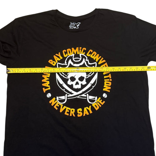Black t-shirt with a skull and swords design and text, measured by a yellow tape measure.