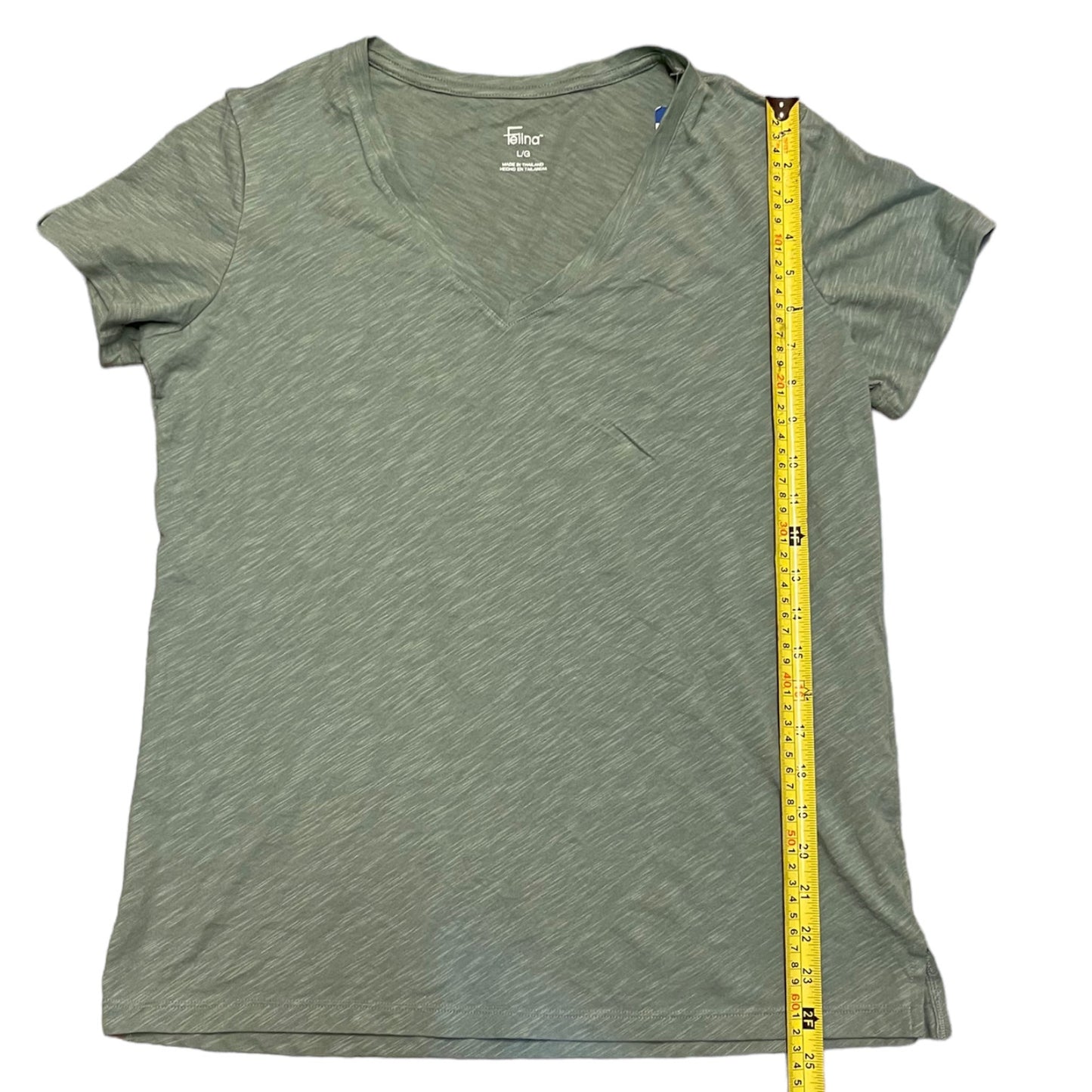 Green t-shirt with a measuring tape on a white background