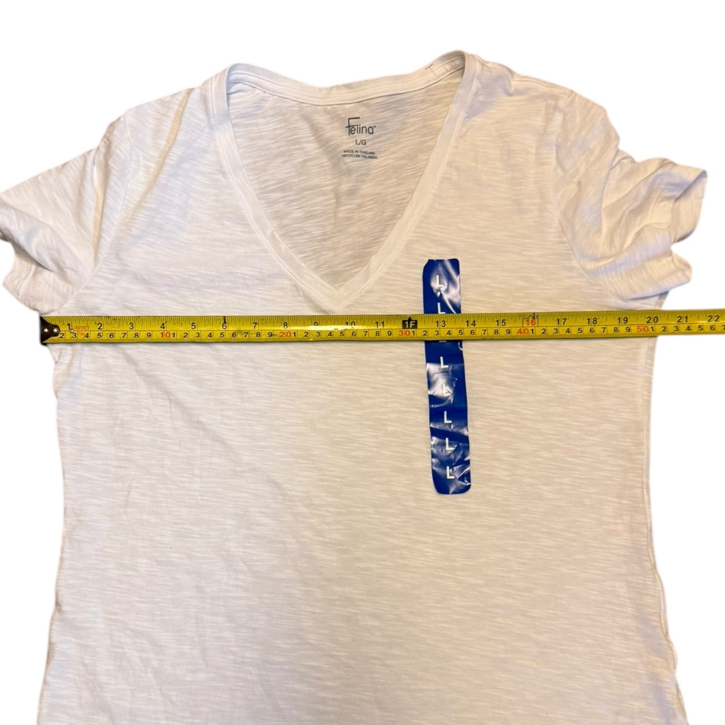 White t-shirt with a measuring tape on a white background