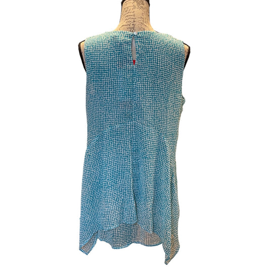 A sleeveless, high-low blue and white patterned top displayed on a dress form mannequin against a white background.
