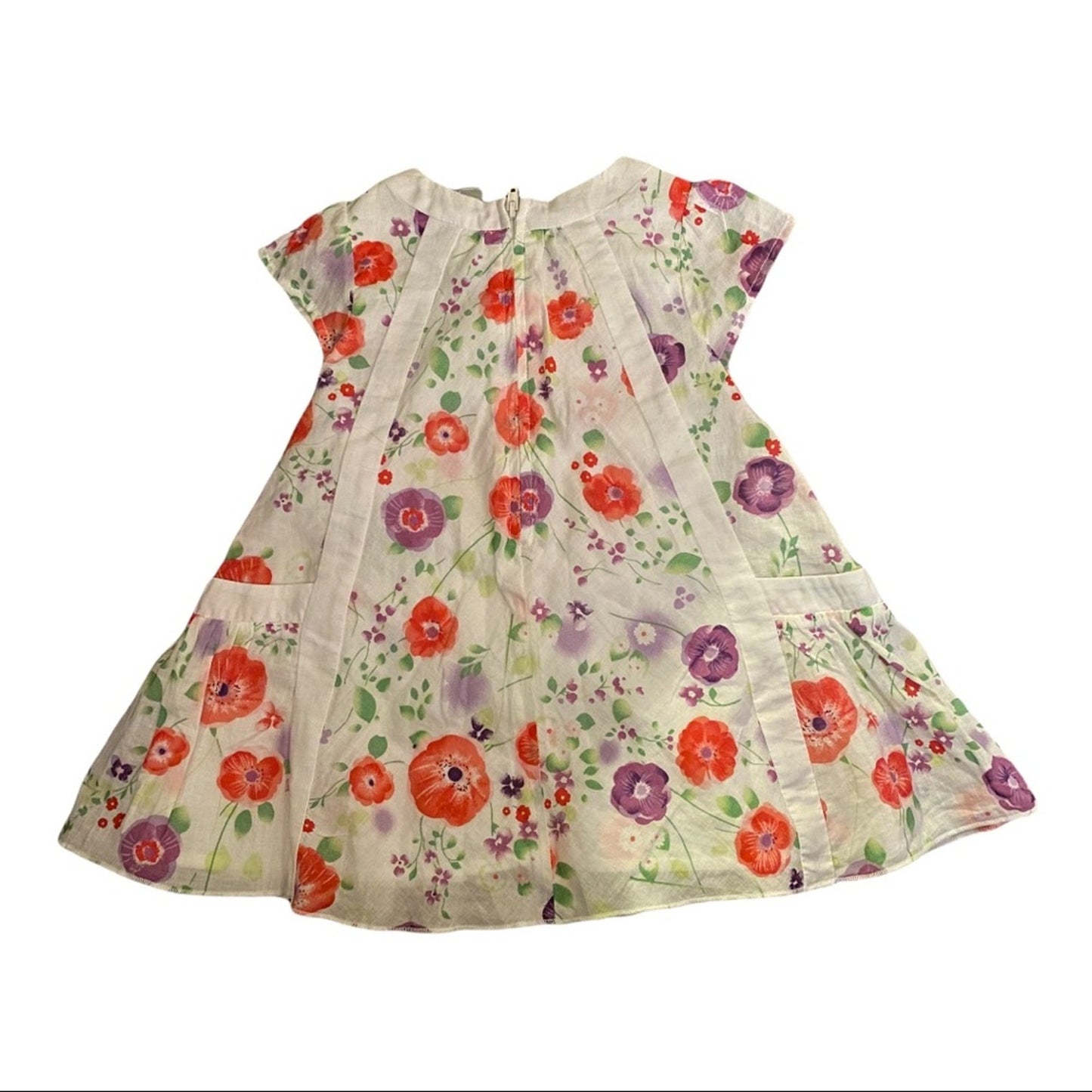 A short-sleeve baby dress with vibrant floral print featuring red poppies, purple flowers, and green leaves on a cream-colored background.