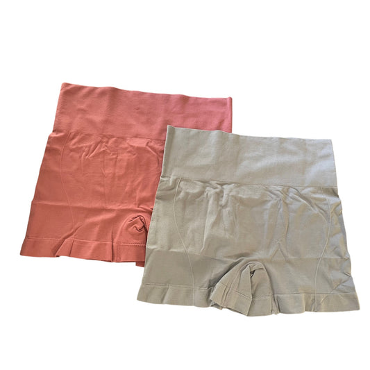 Two pairs of women's shorts, one orange and one gray, on a white background.