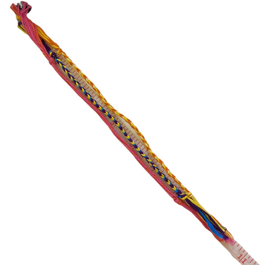 Set of 3 friendship bracelets laying flat on a measuring tape to show length on a white background.