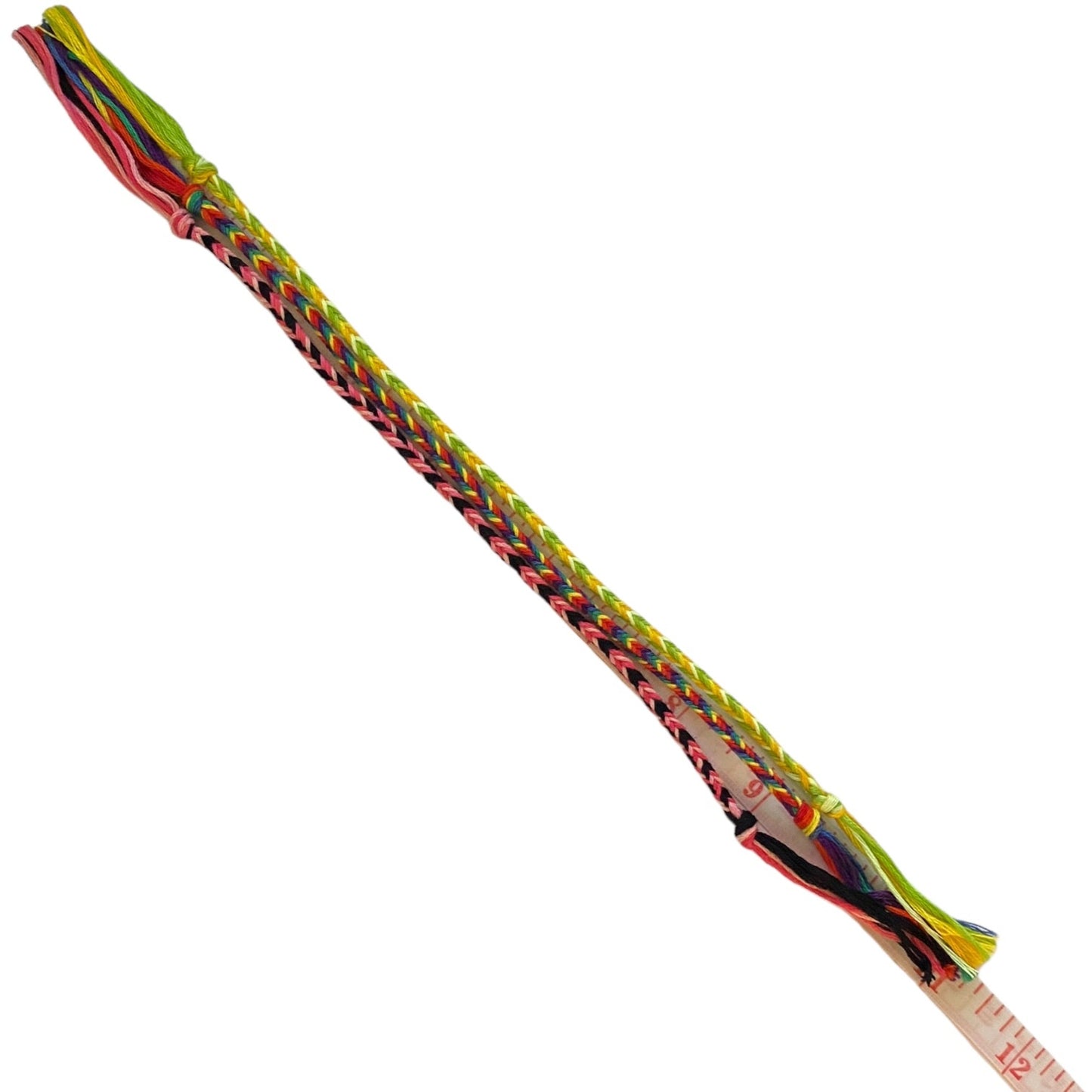 3 multicolor friendship bracelets. A small measuring tape is visible near one end.