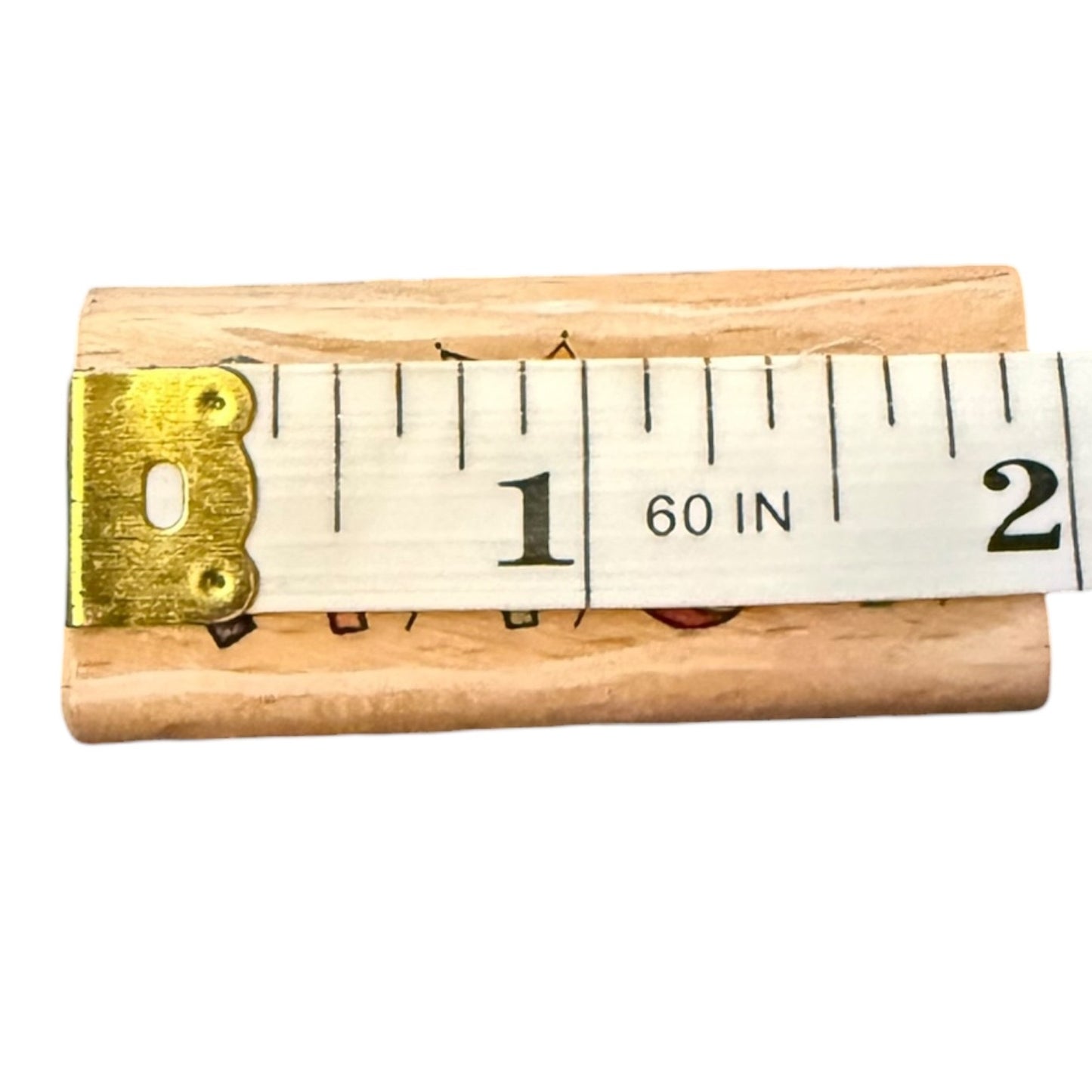 Wooden tape measure on a wood block on a white background