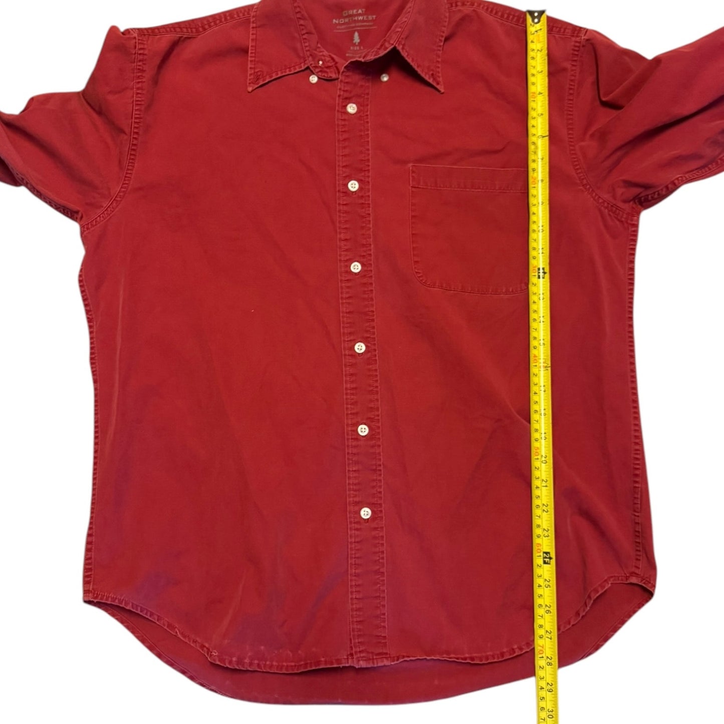 Red shirt with a measuring tape on a white background