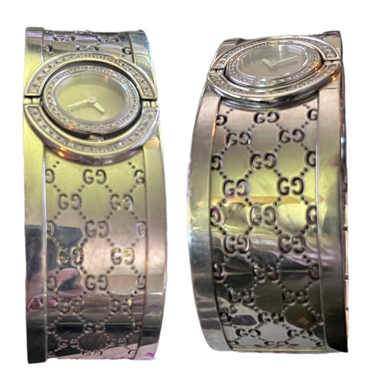 Two views of a Gucci women's watch with a wide, patterned metal bracelet featuring the interlocking GG logo and a diamond-studded bezel.