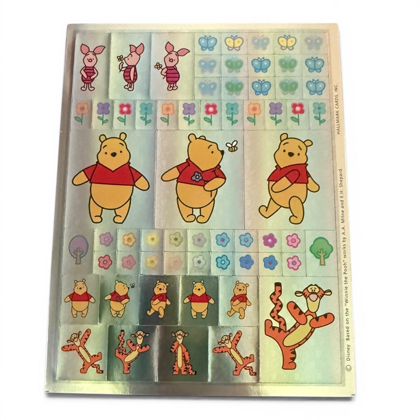 Sheet of Winnie the Pooh stickers with various poses and elements on a white background