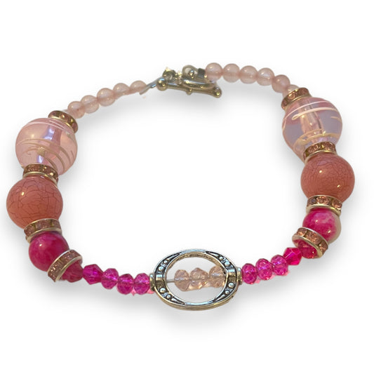 Bracelet with pink beads on a white background