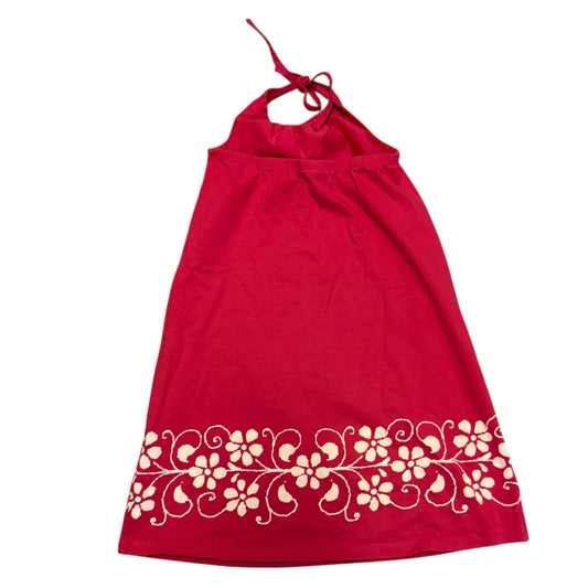 Back of pink dress with white floral design on a white background