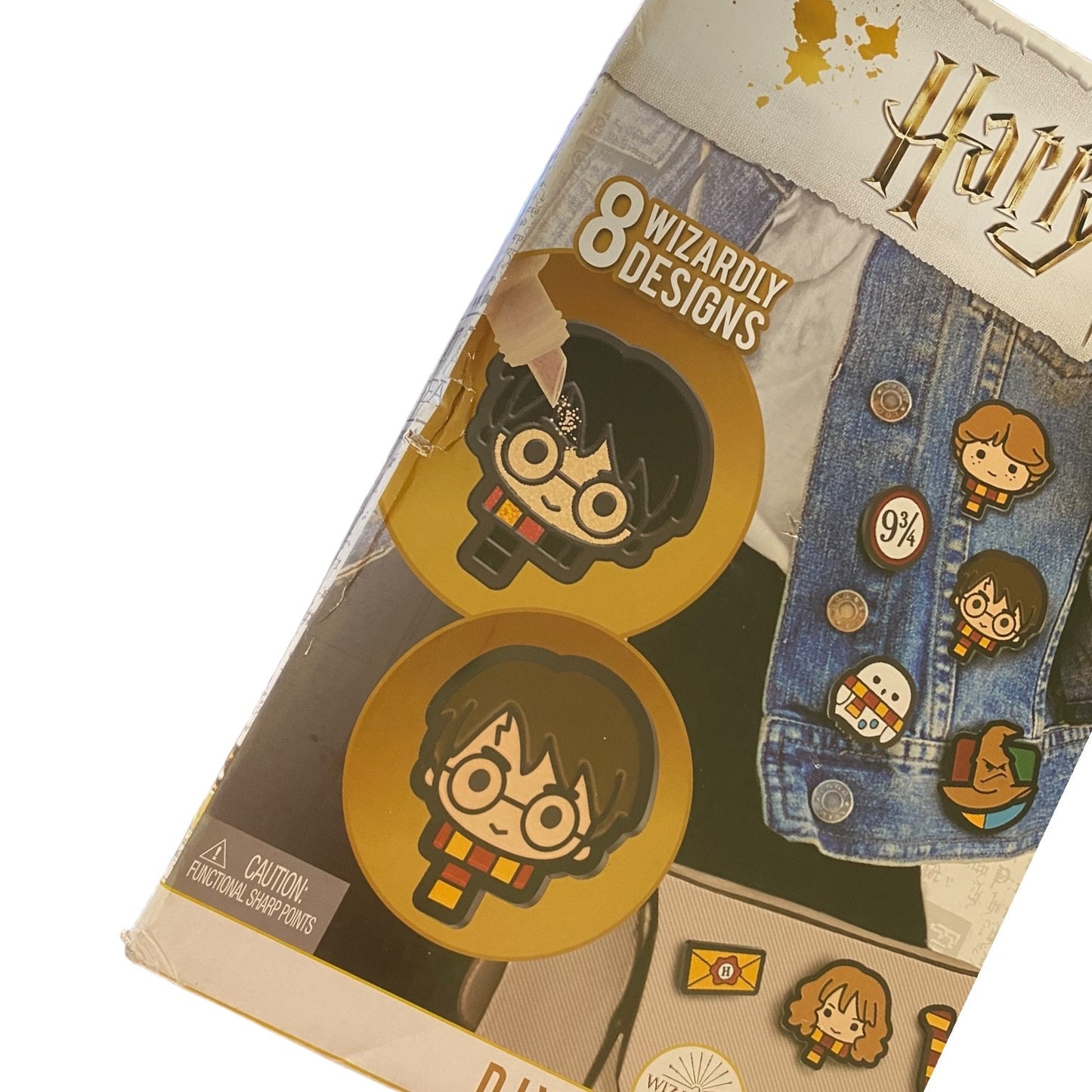 Pack of Harry Potter-themed pins with packaging showing designs and branding with damage to the box