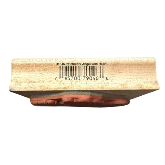 Wooden stamp with a patchwork angel design on a white background