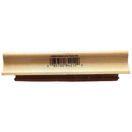 Wooden stamp with a barcode label on a white background