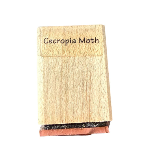 Wooden stamp with 'Cecropia Moth' text on a white background