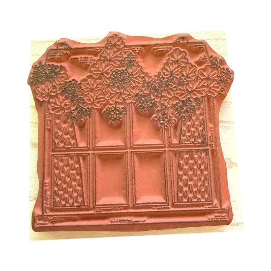Decorative window stamp with floral patterns on a wooden surface