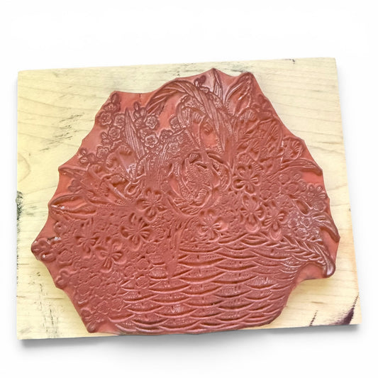 Decorative wooden stamp with floral design on a white background