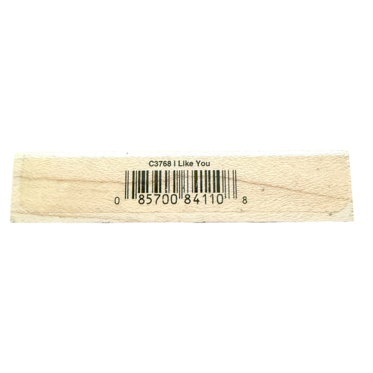 Strip of wood block with a barcode and text on a white background