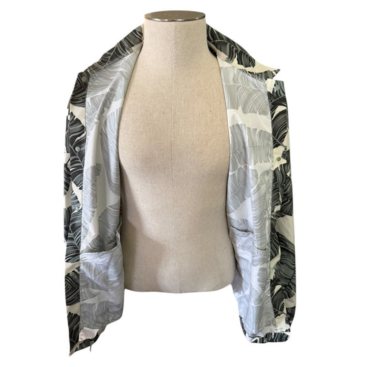 Mannequin wearing a [alm leaf patterned jacket while showing the jacket open on a white background