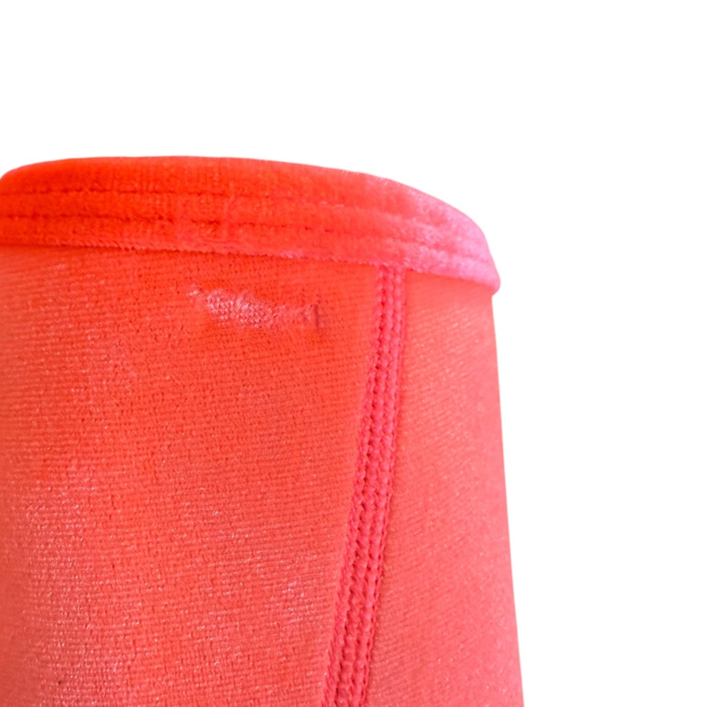 Close-up of a textured fabric showing an indention against a plain white background.