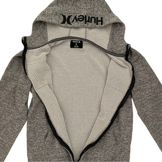 A gray heather zip-up jacket shown open, displaying the black Hurley logo on the inside of the hood and the black zipper trim. The interior lining is a mesh pattern.