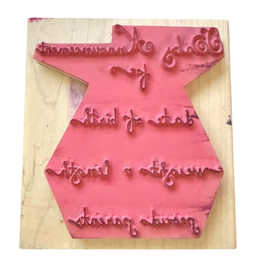 Pink stamp on a wooden block