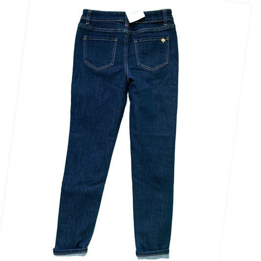 Back view of dark blue denim jeans with a white paper tag at the waistband, displayed on a plain white background.