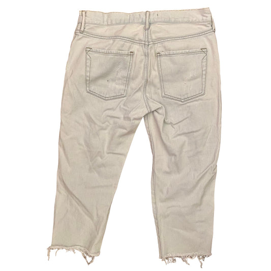Light blue distressed jeans on a white background