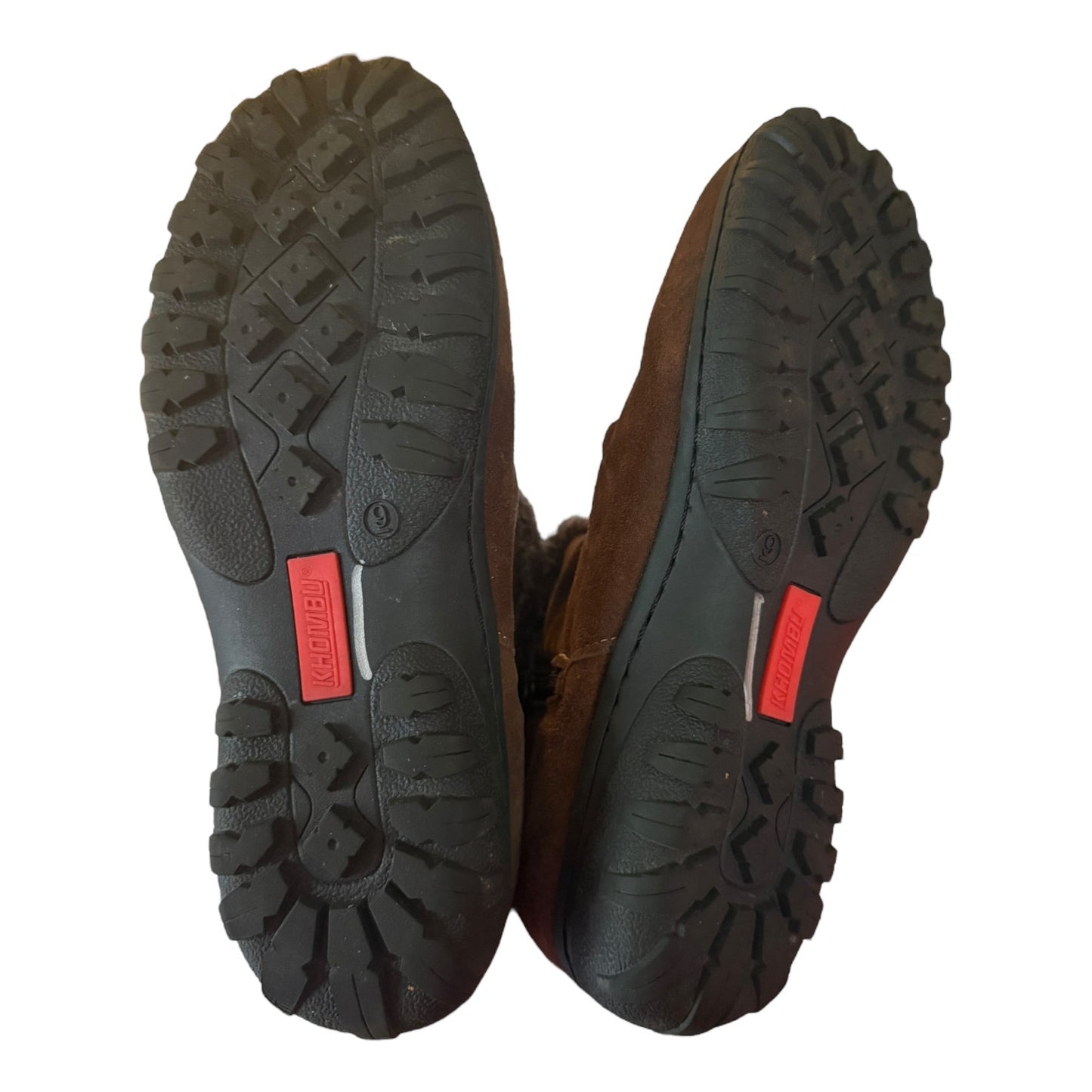 Brown shoes with black soles on a white background