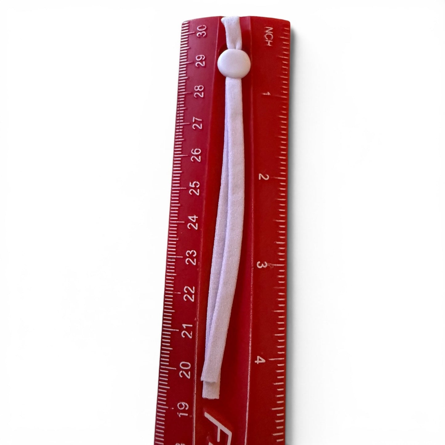 Red ruler with a purple pull tab on a white background