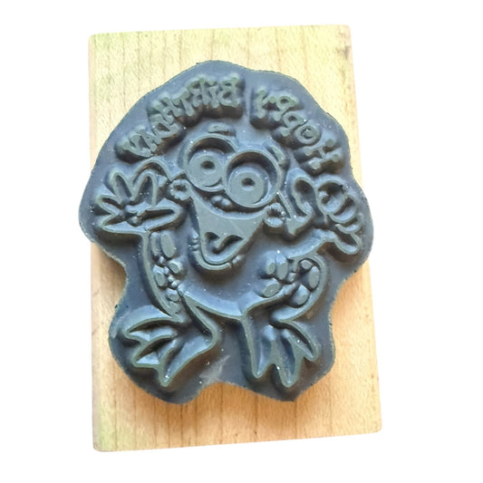 Decorative stamp with a frog design on a wooden block