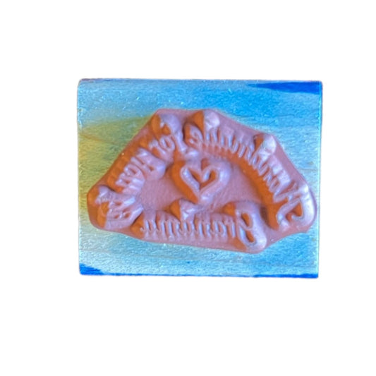 Decorative stamp with intricate design on a white background
