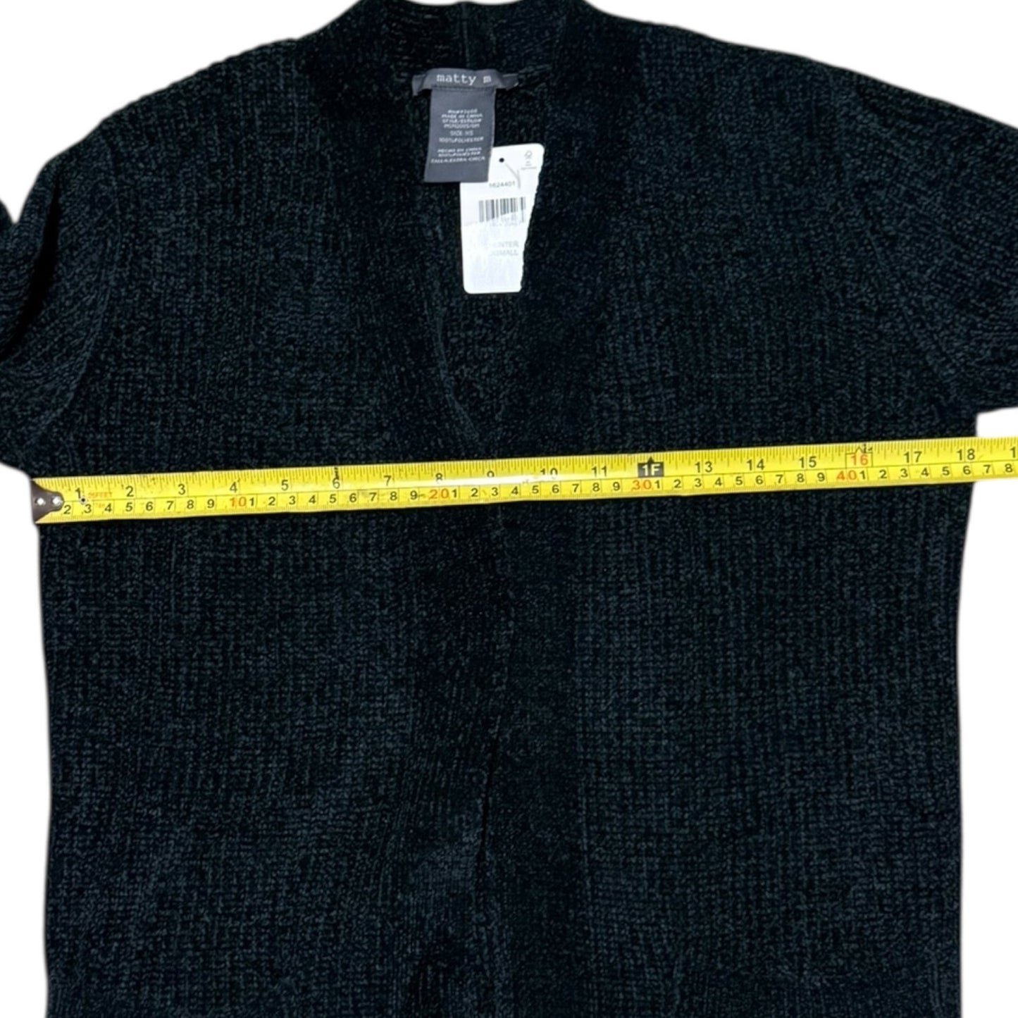 Green sweater with a measuring tape around it, on a white background