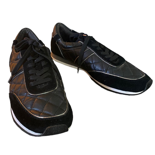 Pair of black sneaker shoes on a white background