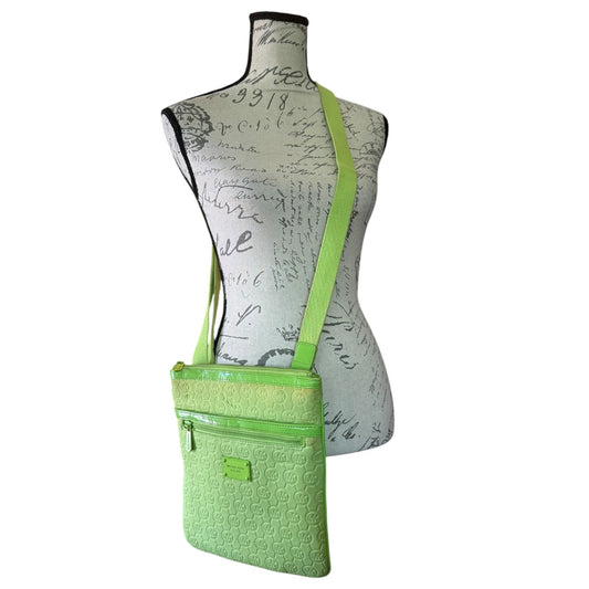 A bright lime green crossbody bag with a matching shoulder strap, displayed on a vintage-style dress form mannequin against a plain white background.