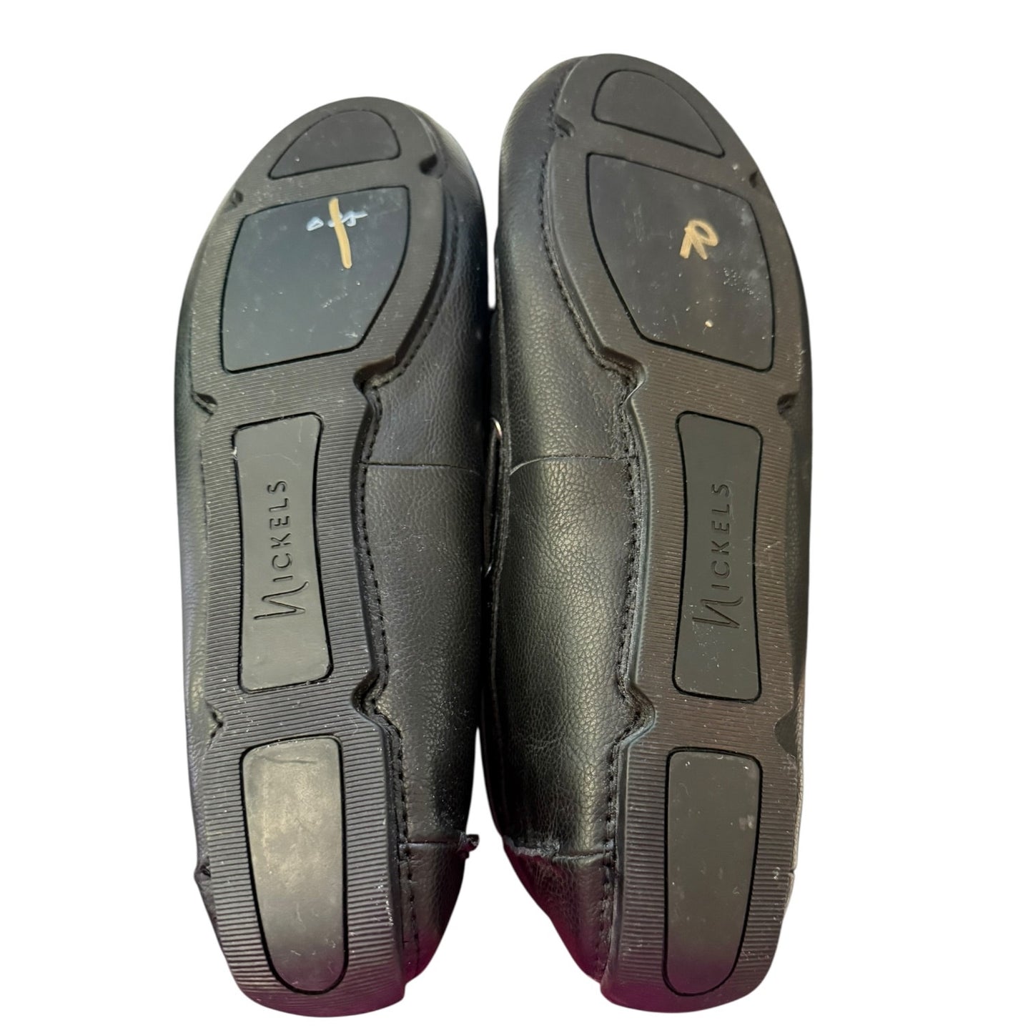 A pair of black slip-on shoes shown from the sole side on a white background