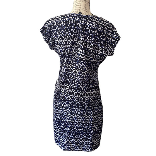 A short-sleeve knee-length dress with a dense abstract print , displayed on a mannequin torso against a plain white background.