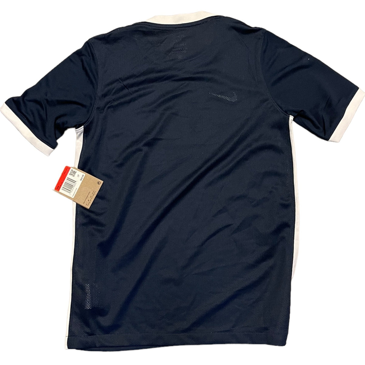 A navy blue short-sleeve athletic shirt with white trim on the collar and sleeve cuffs, shown from the back with a hangtag attached.