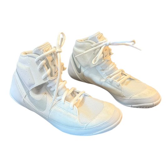 A pair of white high-top Nike sneakers with white laces , shown against a plain white background.
