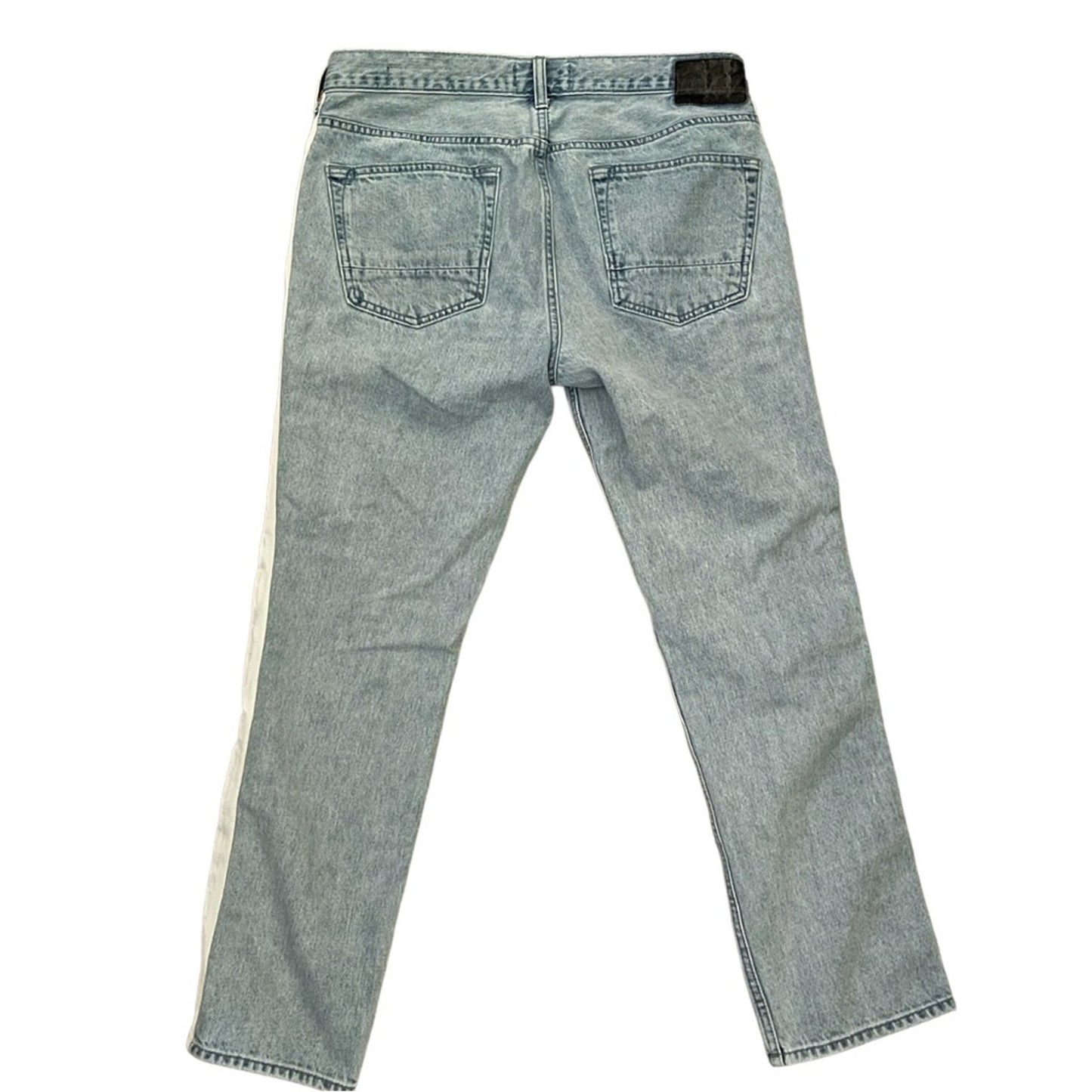 Light wash blue denim jeans shown from the back, featuring a light beige stripe running down the side of each leg.
